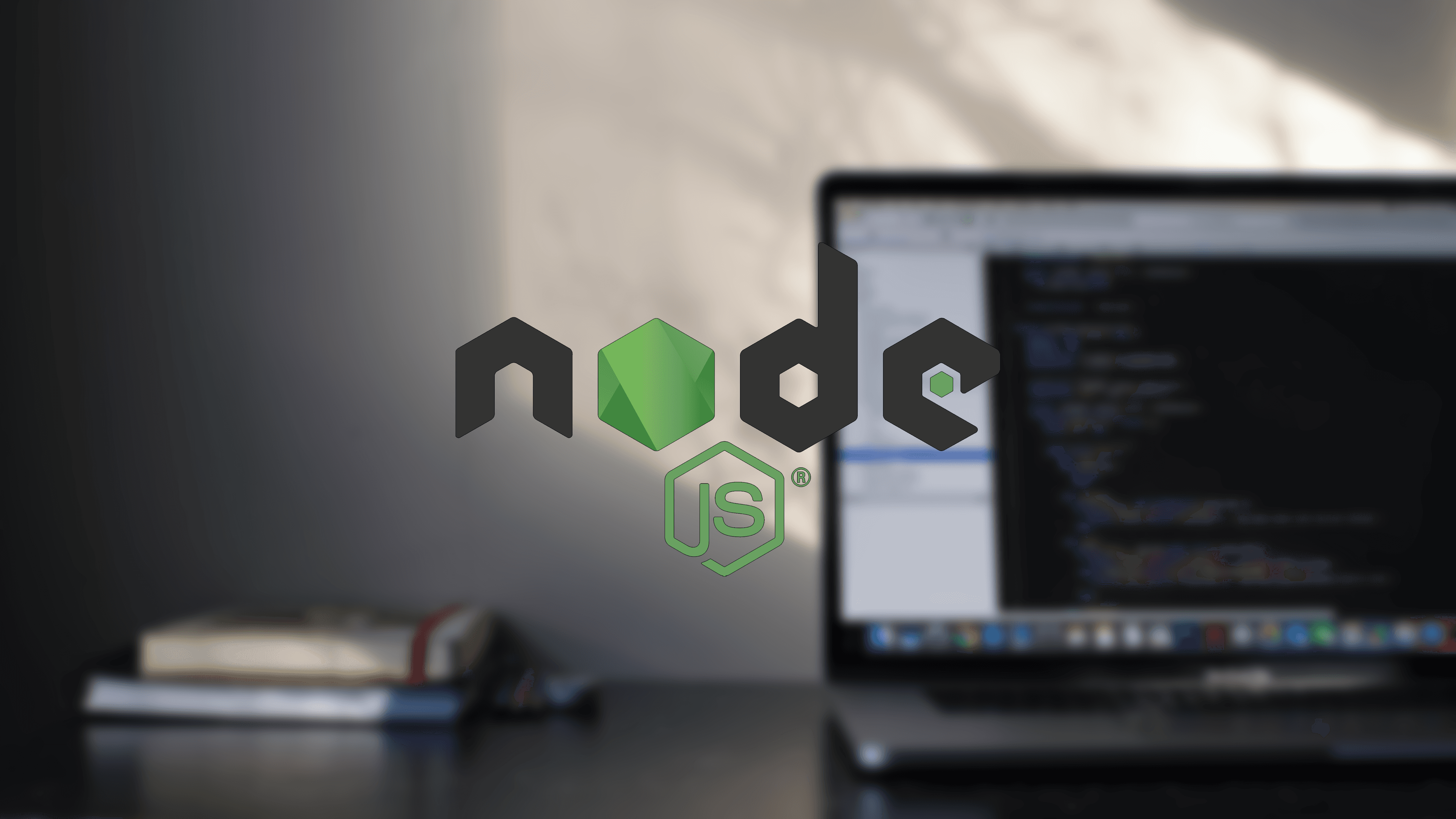 Laptop with code on-screen with Node.js logo